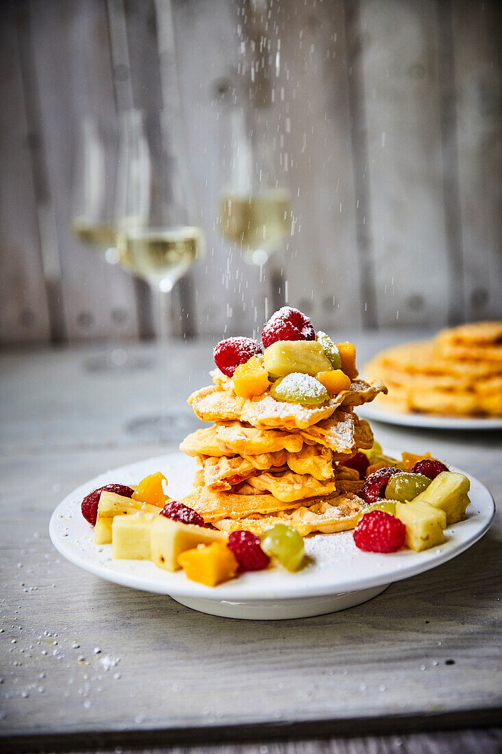 Carrot waffles with fruit and icing sugar