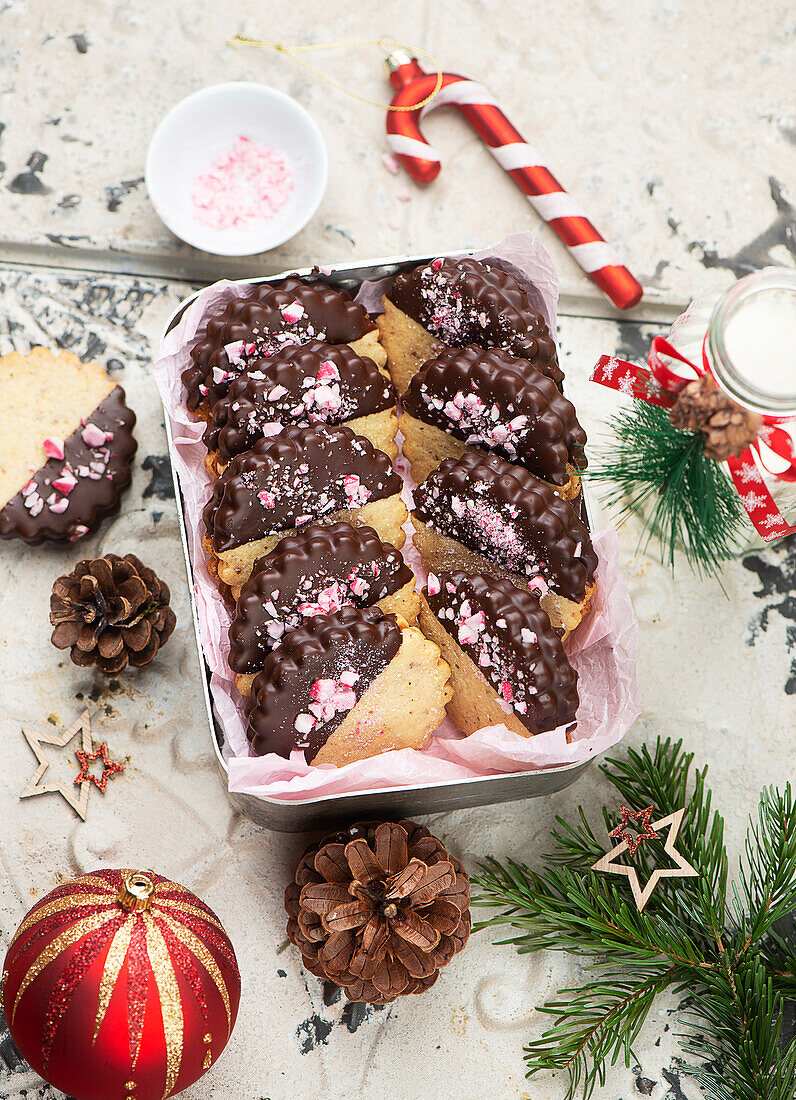 Nut nougat sandwich cookies dipped in chocolate with crushed candy cane