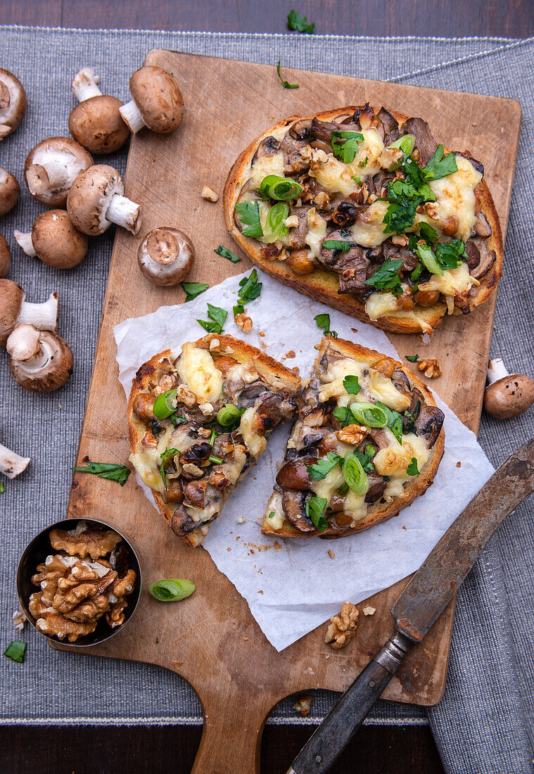 Baked bread topped with mushrooms, almond cheese and tofu