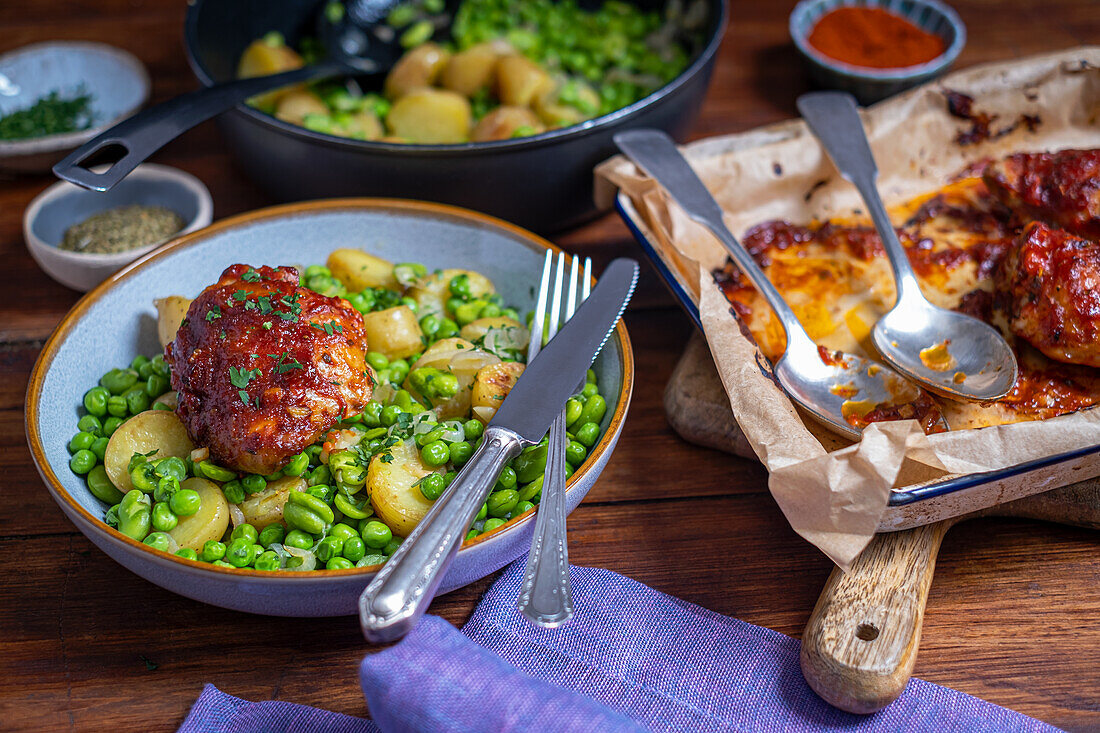 Potatoes with broad beans, green peas and baked chicken