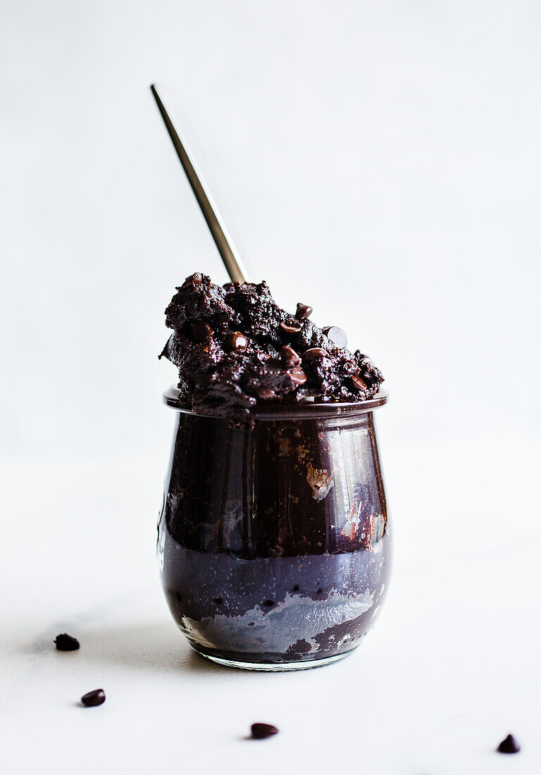 Edible brownie batter with chocolate chips in a jar