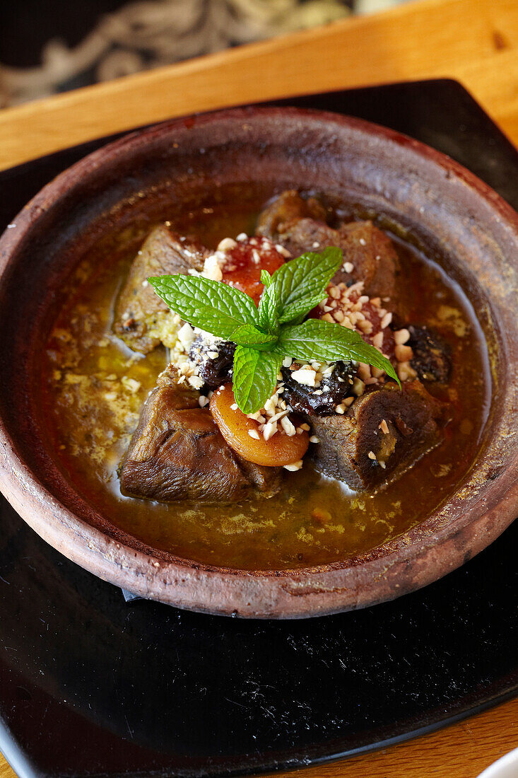 Lamb tajine with cinnamon honey plums and almonds