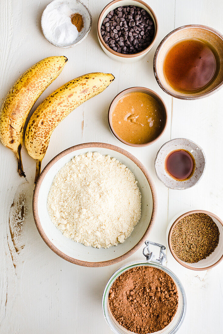 Ripe bananas and bowls with various ingredients
