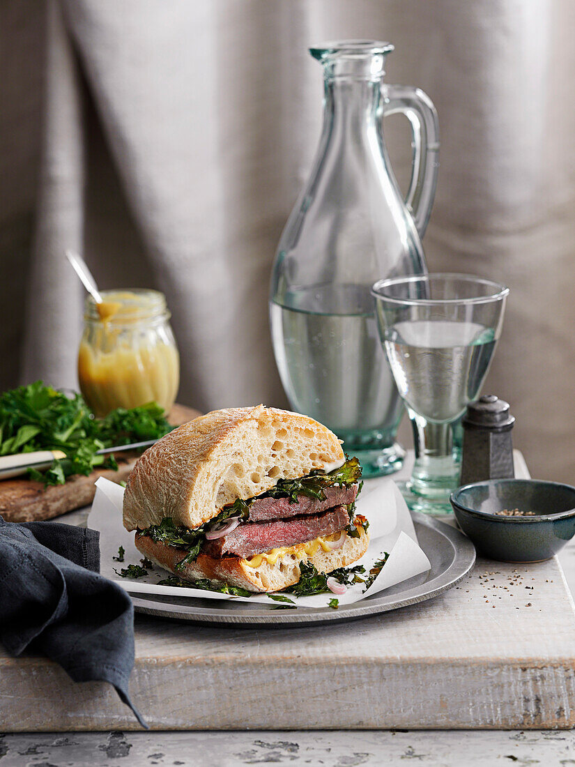Steak and kale sandwich with mustard