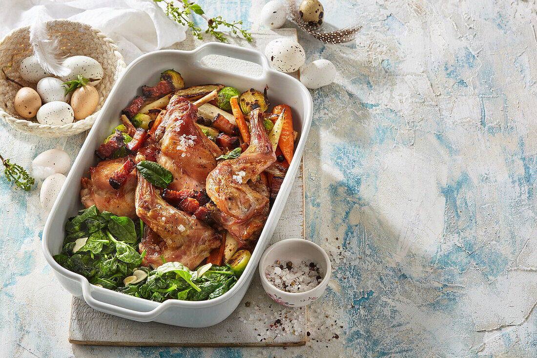 Oven-baked rabbit with vegetables and bacon