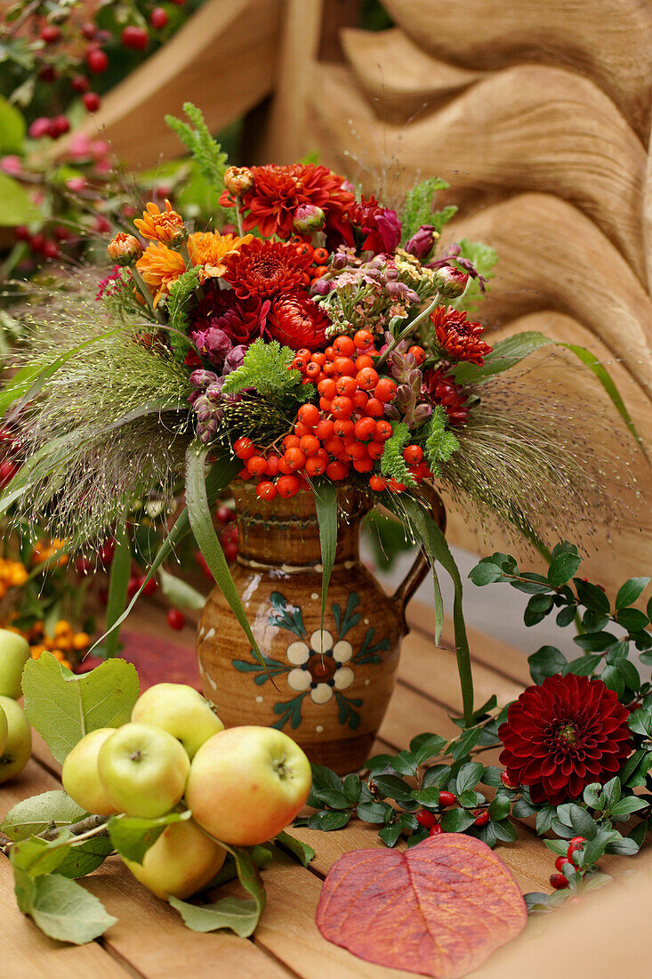 Autumn bouquet of chrysanthemums, rowan berries, strawflowers and snapdragons