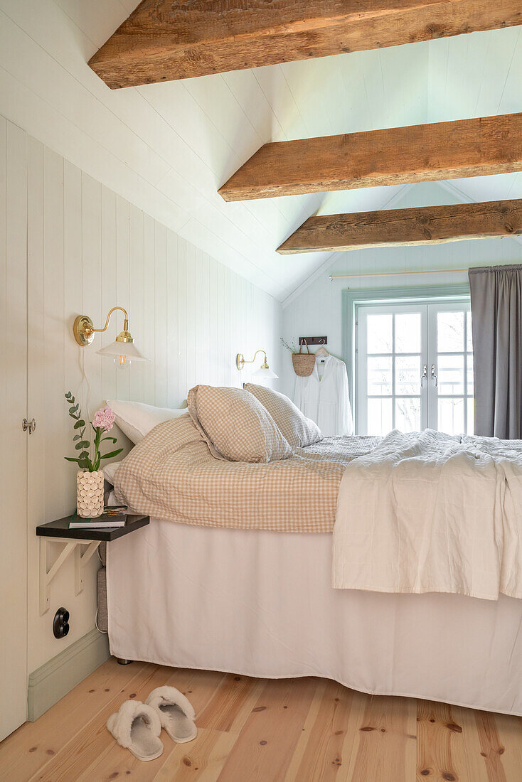 Brightly decorated bedroom with exposed wooden beams