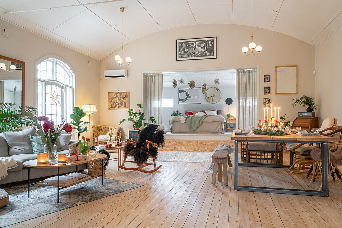 Open-plan living room with sitting room, steps and view of the bedroom