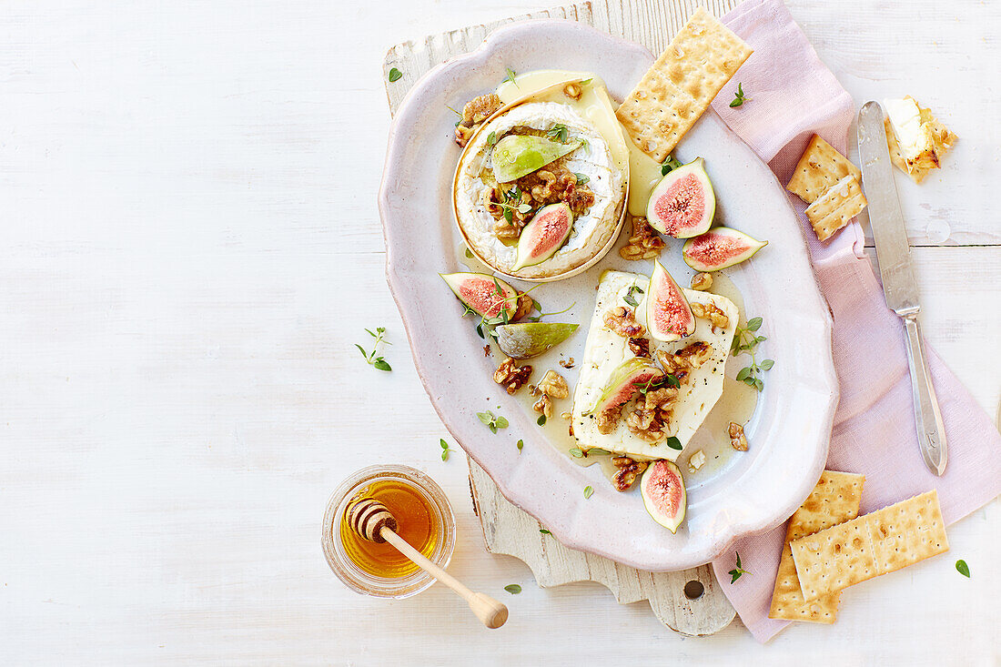 Baked camembert and feta with figs, honey, walnuts, and crackers