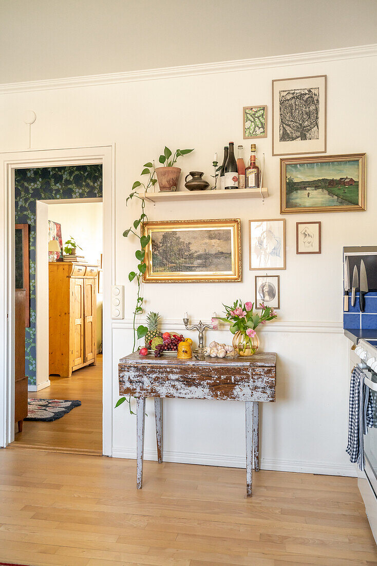 Vintage-style console table with decorations and picture gallery on the wall