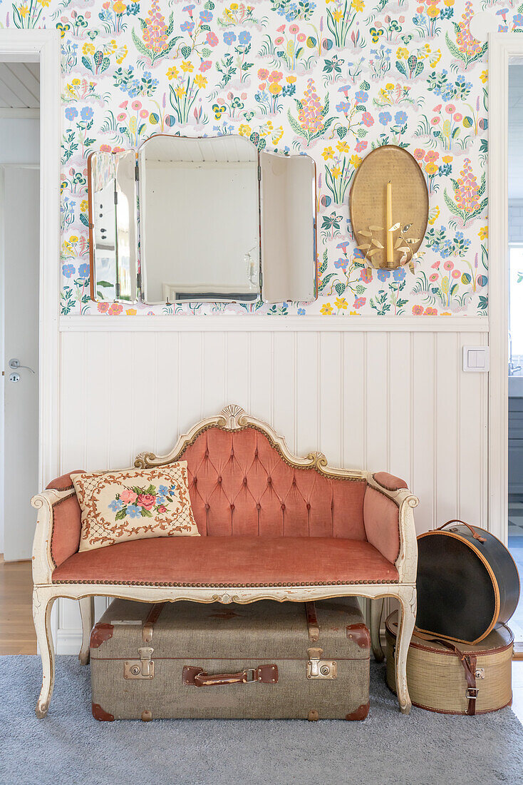 Antique bench, vintage suitcase and wallpaper with floral pattern