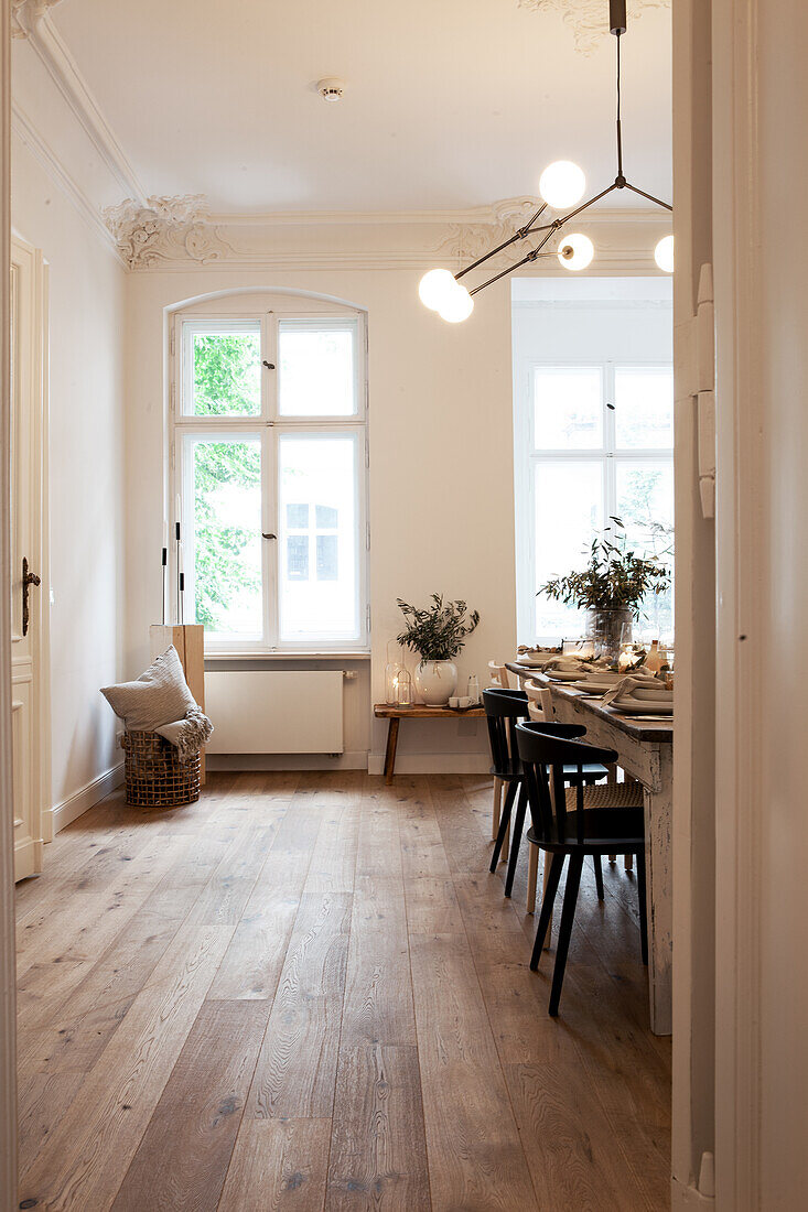 Dining room with wooden table, black chairs and stucco ceiling