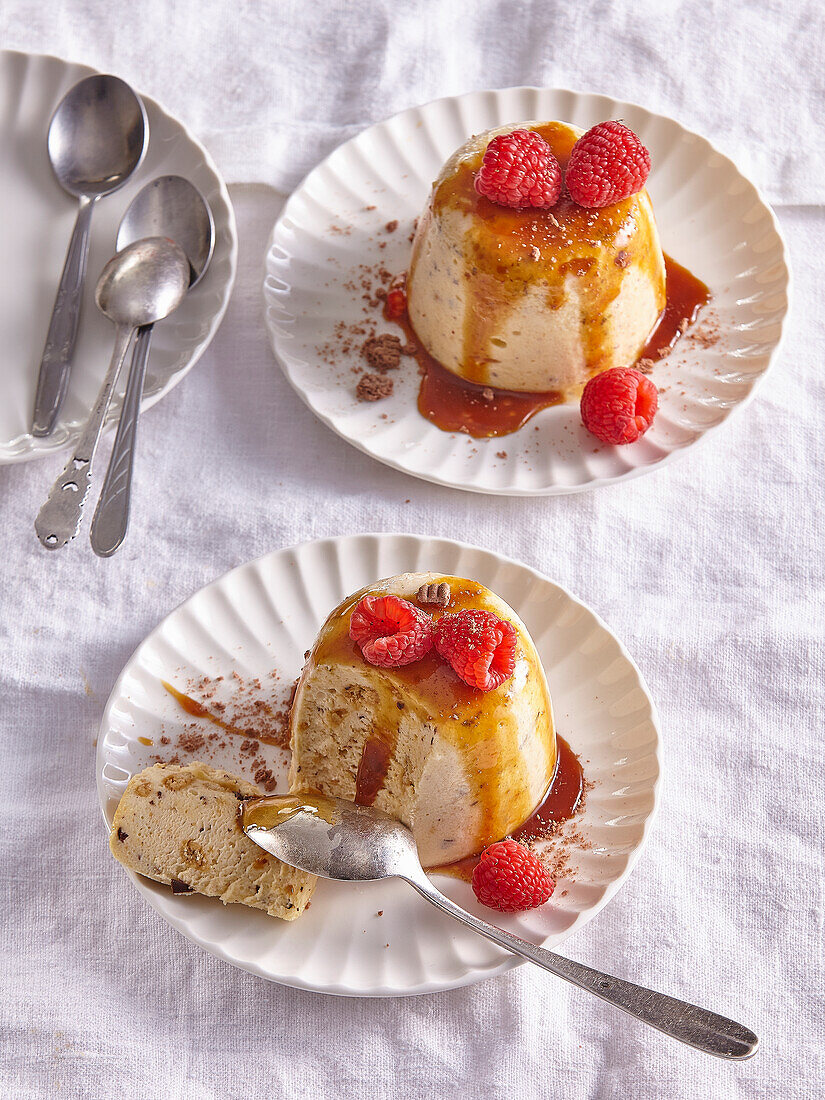 Frozen coffee mousse with caramel sauce and raspberries