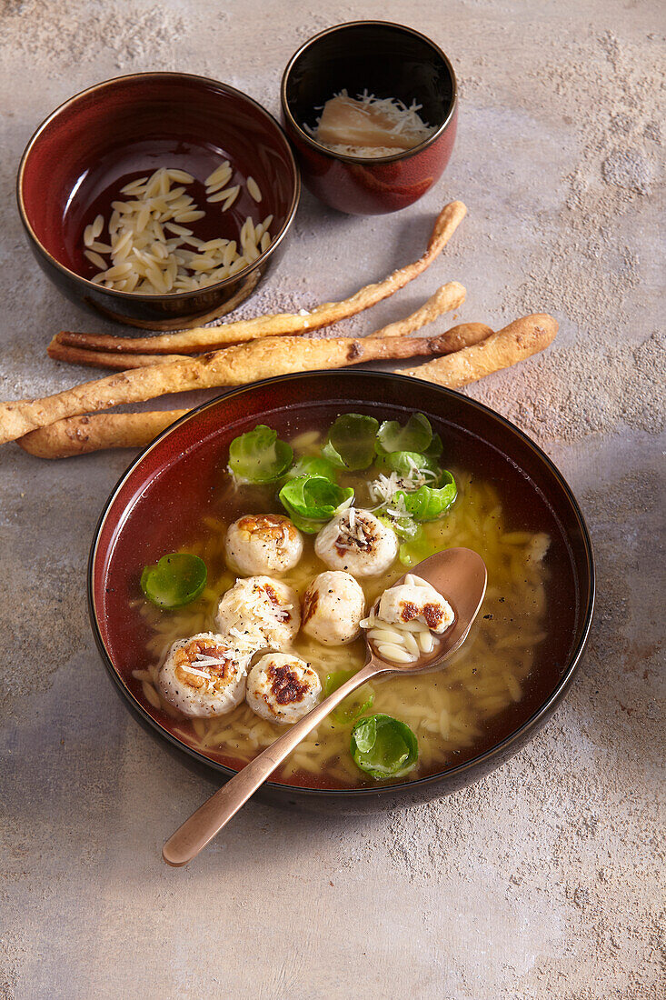 Chicken broth with meatballs and brussels sprouts