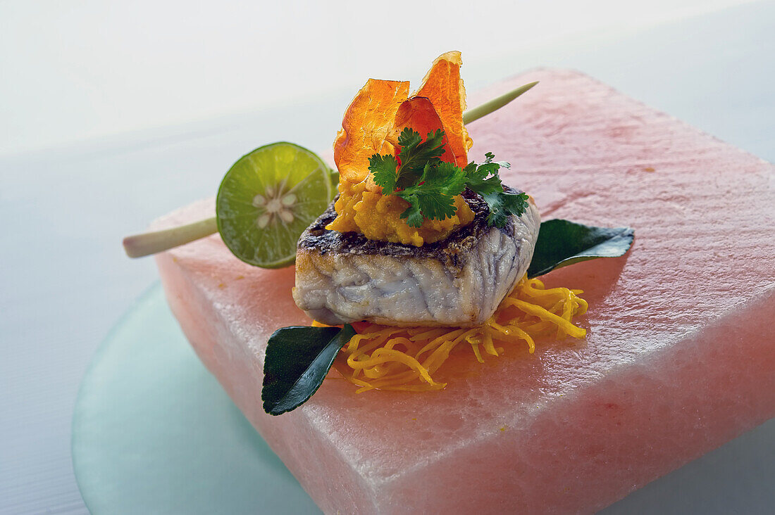 Barramundi with pumpkin puree and pancetta on salt block