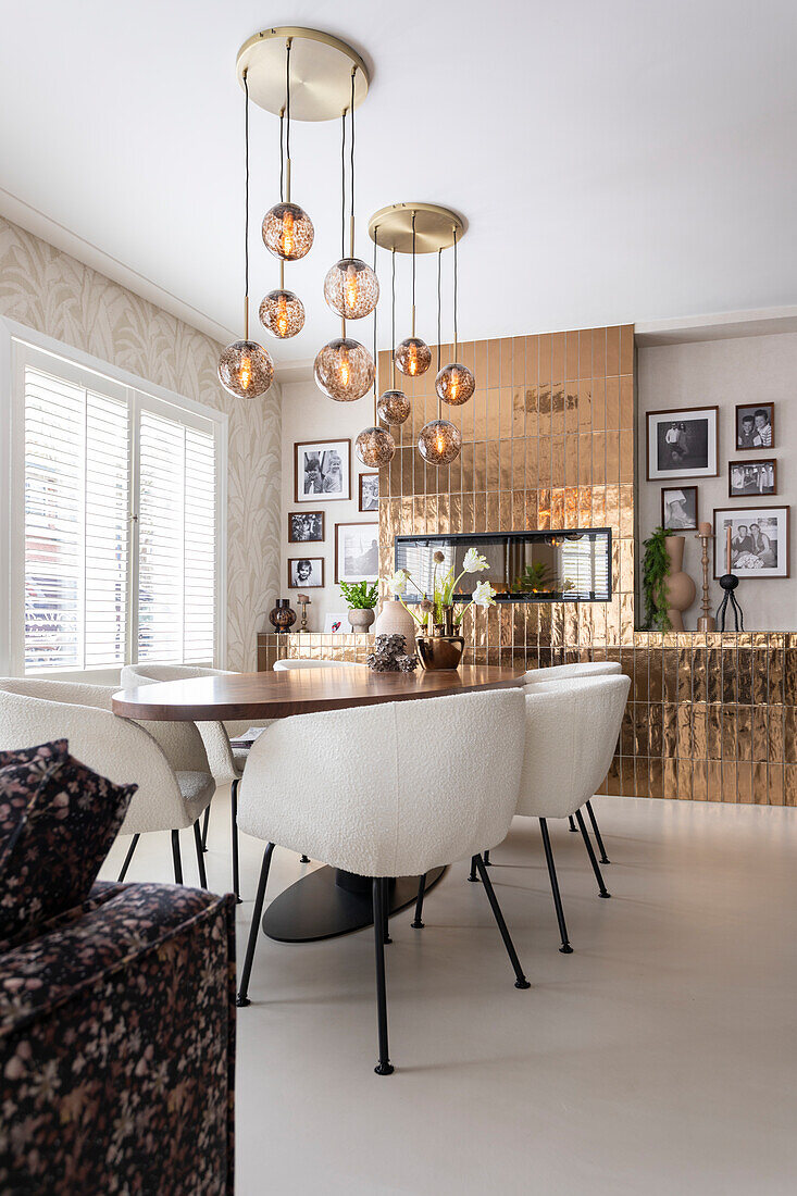 Dining area with modern pendant lights and photo wall