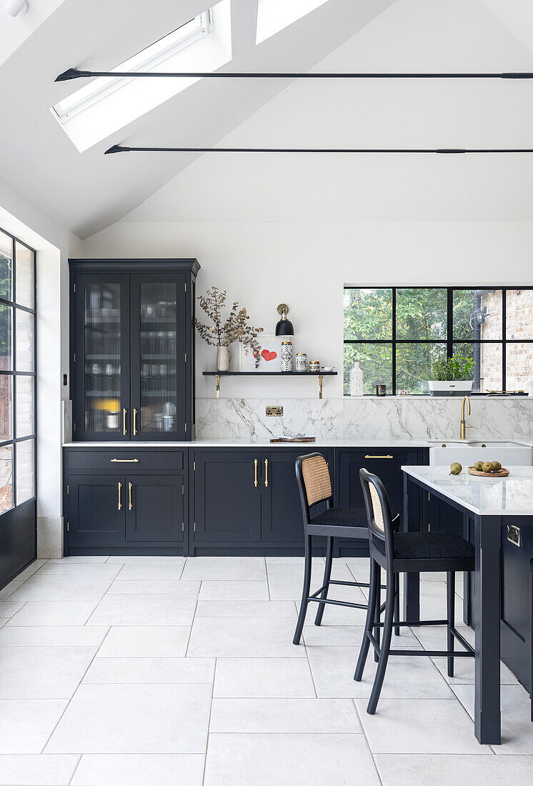 Modern kitchen with black cabinets and marble worktop