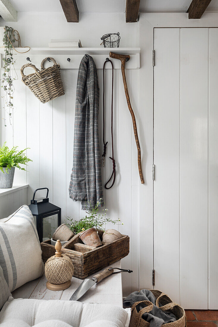 White country-style hallway with decoration and exposed beams