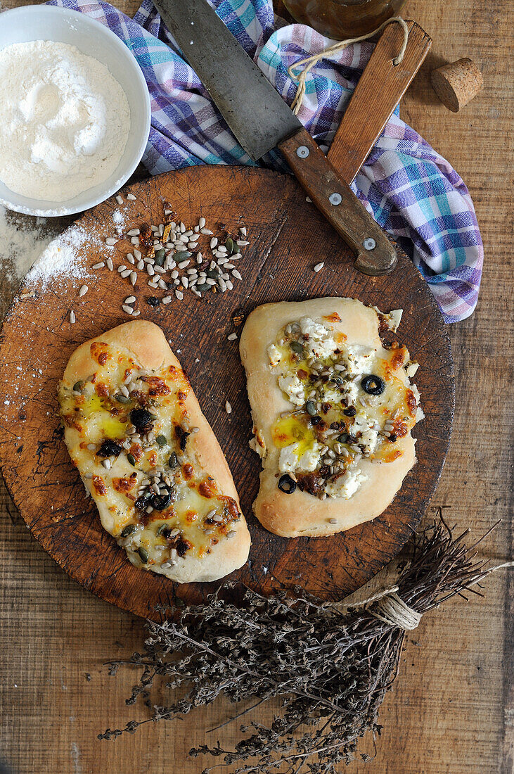 Homemade mini focaccia with ricotta, mixed seeds and olives