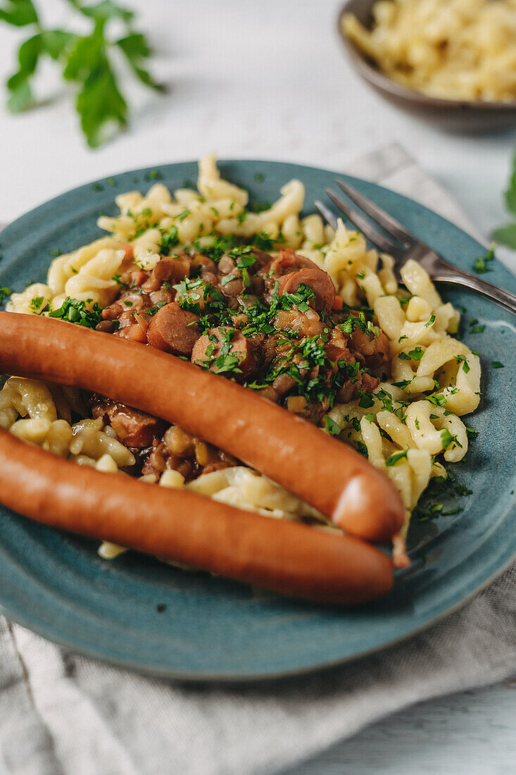 Swabian lentils with homemade spaetzle and string sausages