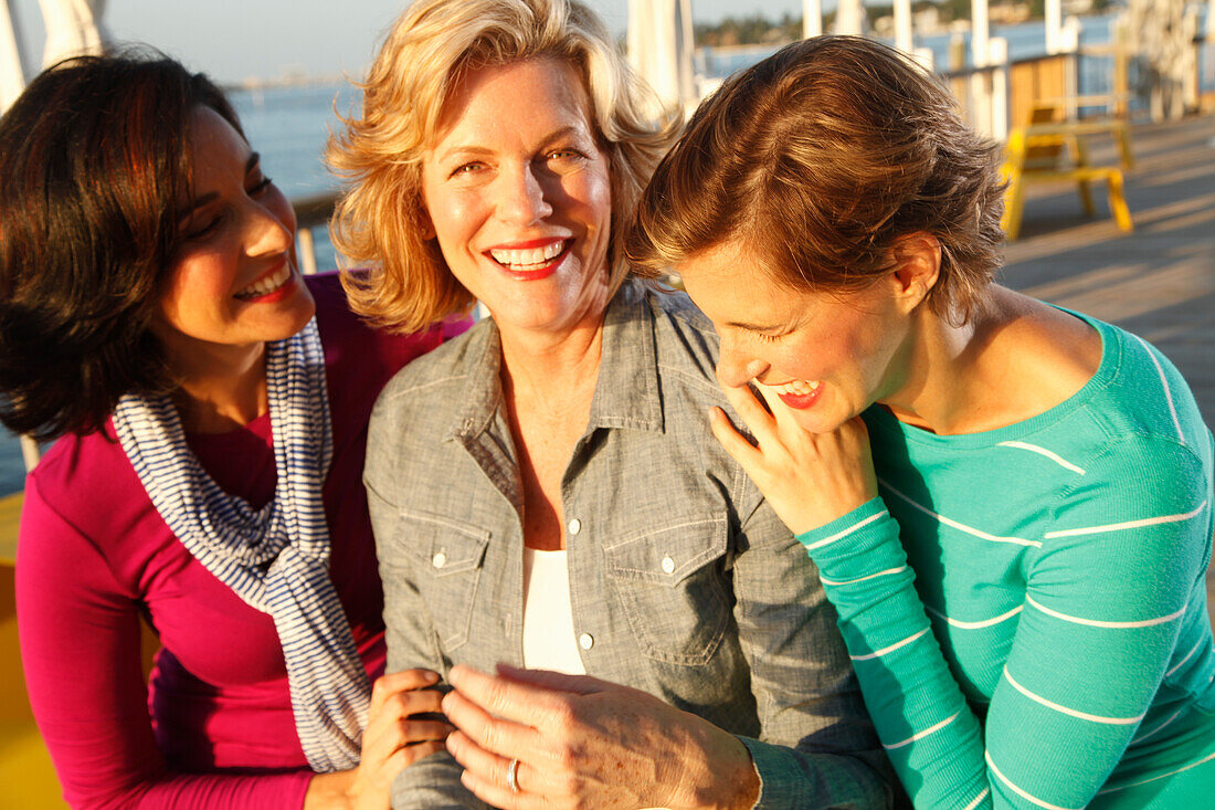 Three good-humoured girlfriends on a ship