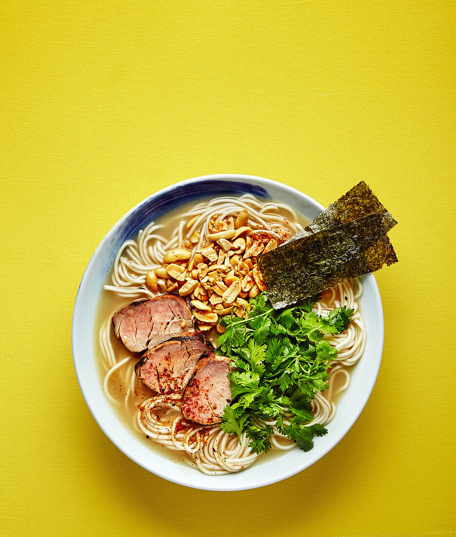 Spicy tonkotsu ramen with grilled pork fillet, peanuts and cilantro