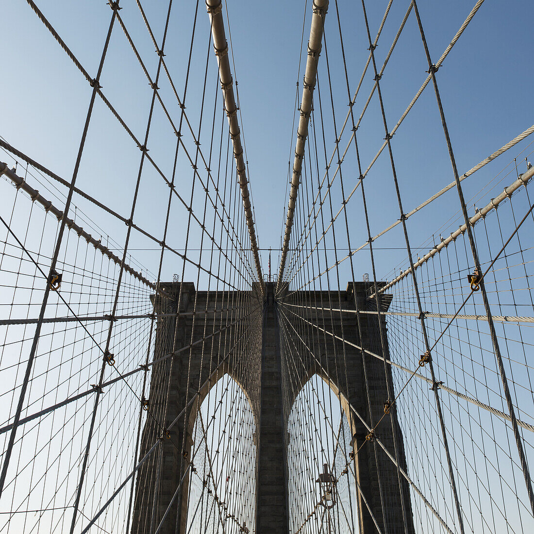 Pattern Of The Cables On A Bridge Against A Blue Sky; New York City, New York, United States Of America