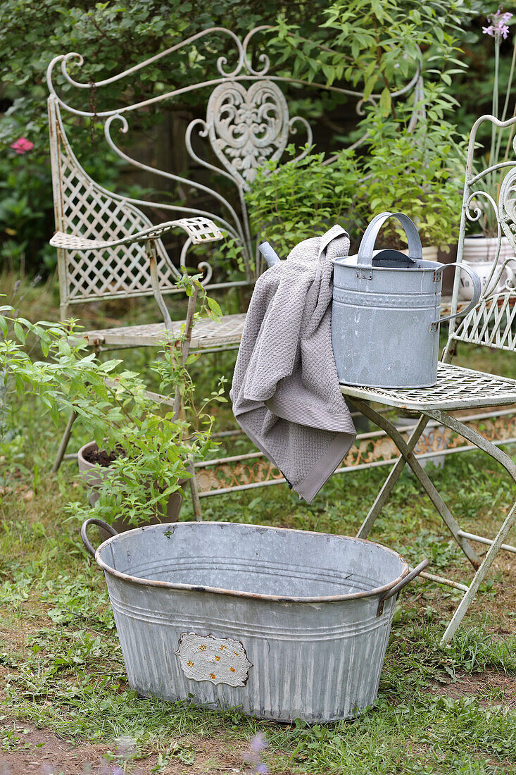 Zinc tub and zinc watering can in the garden