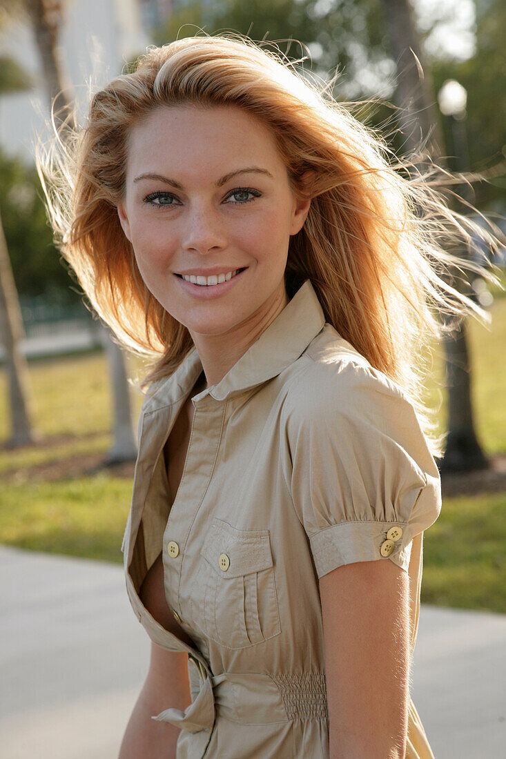 Blonde woman in light blouse dress outside