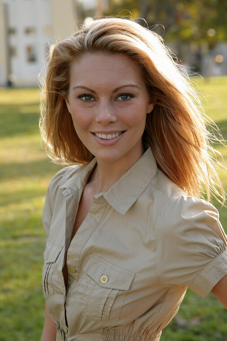 Blonde woman in light blouse dress outside