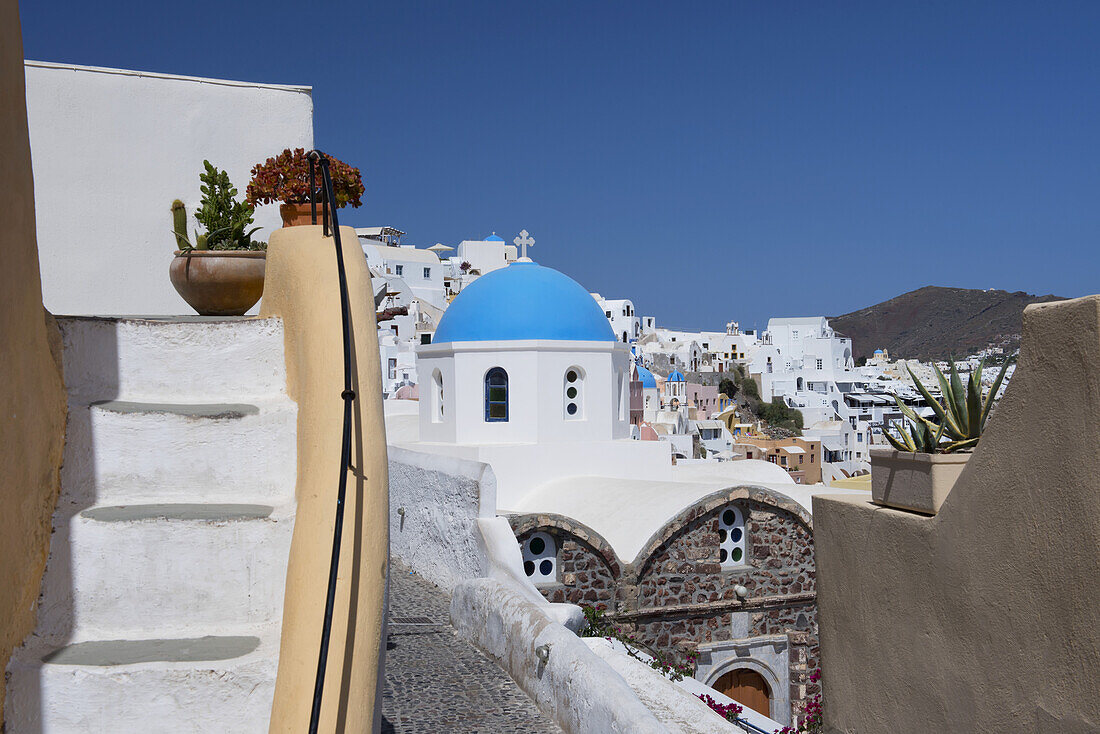 The Blue Domed Church Of St. Nicholas And Bougainvillea Around Stairs; Oia, Santorini, Cyclades, Greek Islands, Greece