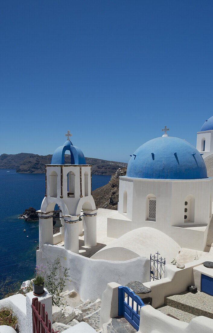 Blue Domed Churches On A Cliff Overlooking The Caldera; Oia, Santorini, Cyclades, Greek Islands, Greece