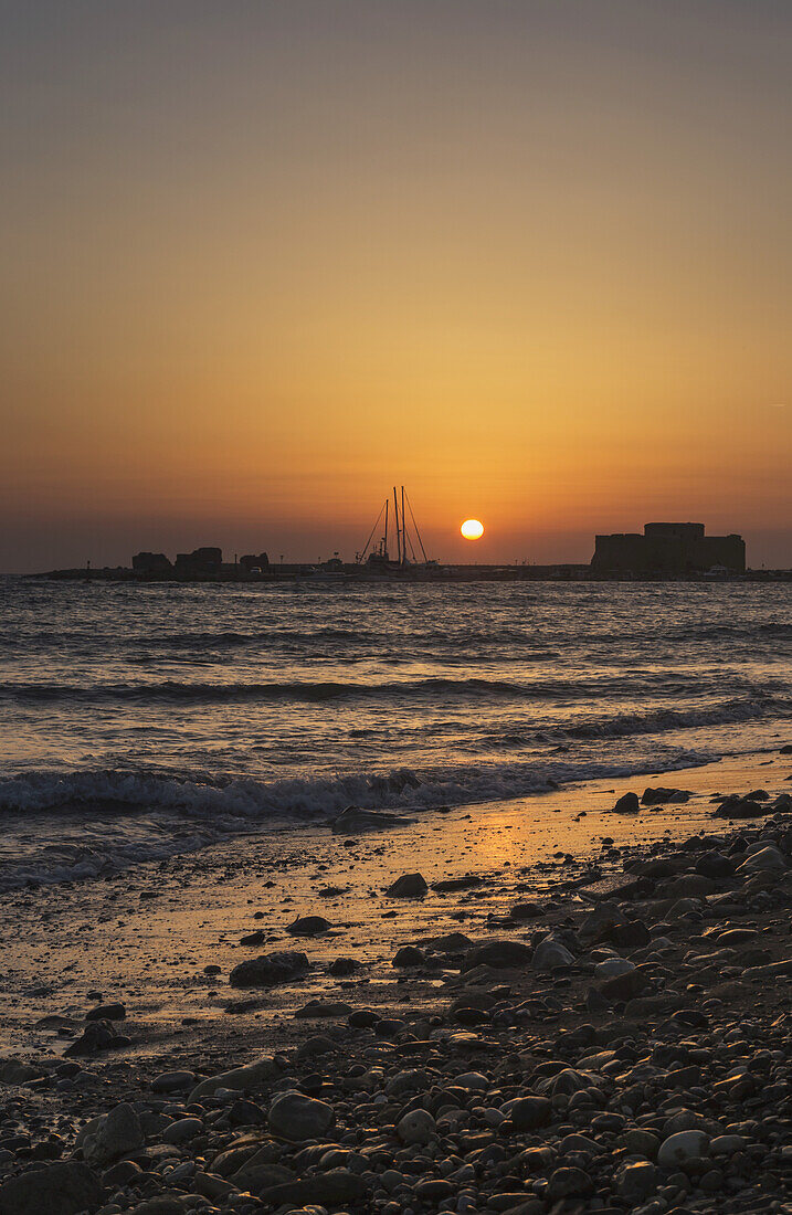 Glowing Orange And Yellow Sky At Sunset Over A Mediterranean Coastline; Paphos, Cyprus