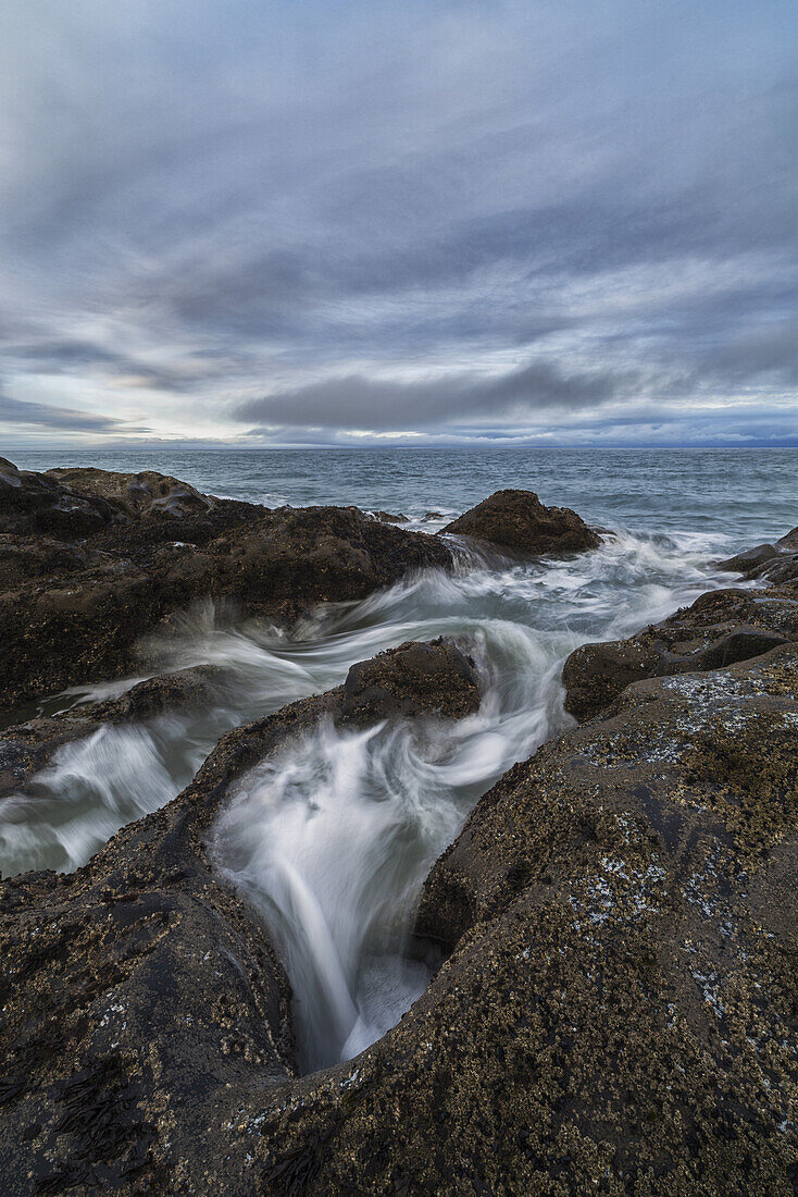 Water Rushes Over The Volcanic Bedrock Near Tow Hill, Haida Gwaii At Sunrise, Naikoon Provincial Park; Masset, British Columbia, Canada