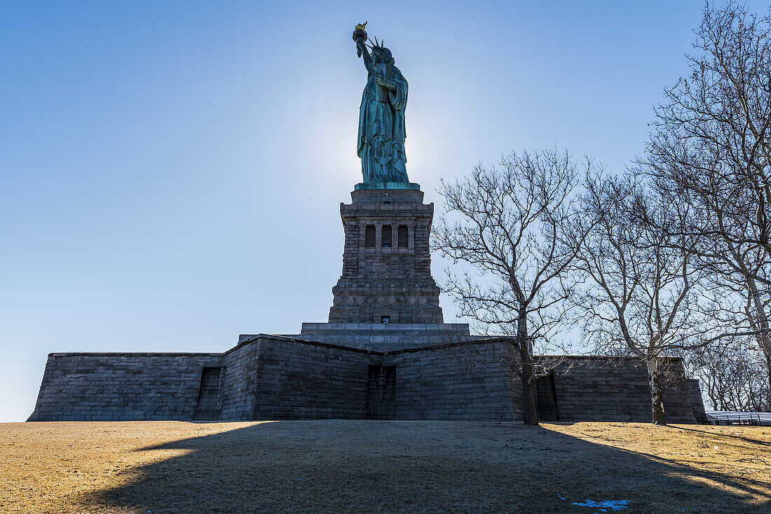 Sonnenuntergang hinter der Freiheitsstatue, Liberty Island; New York City, New York, Vereinigte Staaten Von Amerika