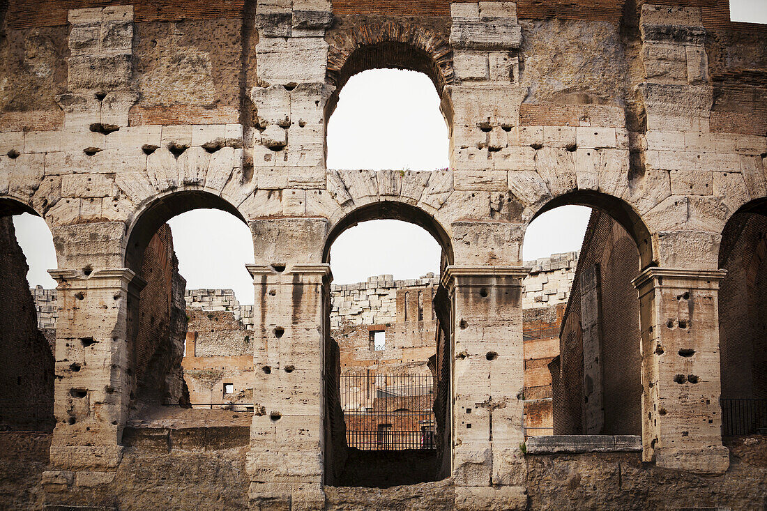 Old Stone Wall Of Colosseum With Arches; Rome, Italy
