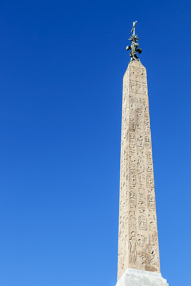 Obelisk With Statue On Top And Etchings On Facade; Rome, Italy