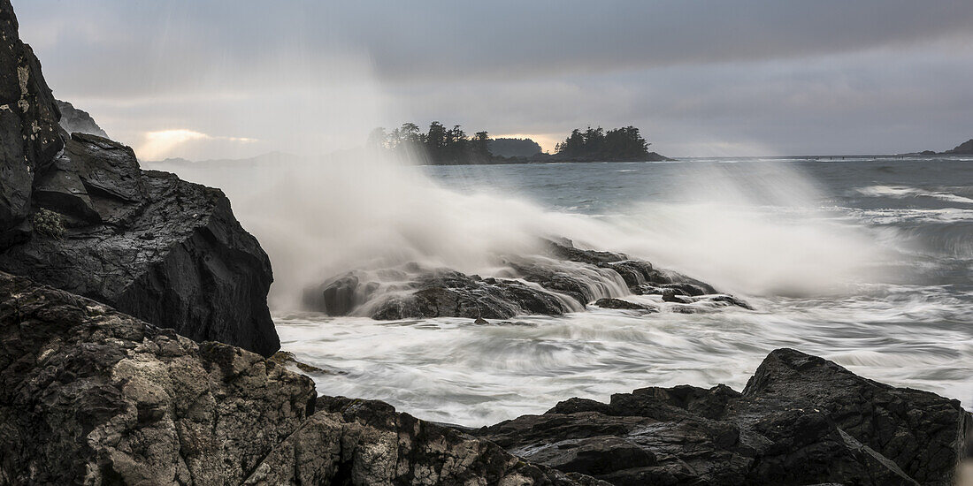 Mist In The Air As Waves Crash Against The Rocky Shore; Tofino, British Columbia, Canada