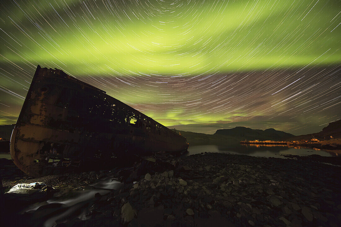 Sternspuren und Nordlichter über der Stadt Djupavik in den Westfjorden von Island; Djupavik, Island