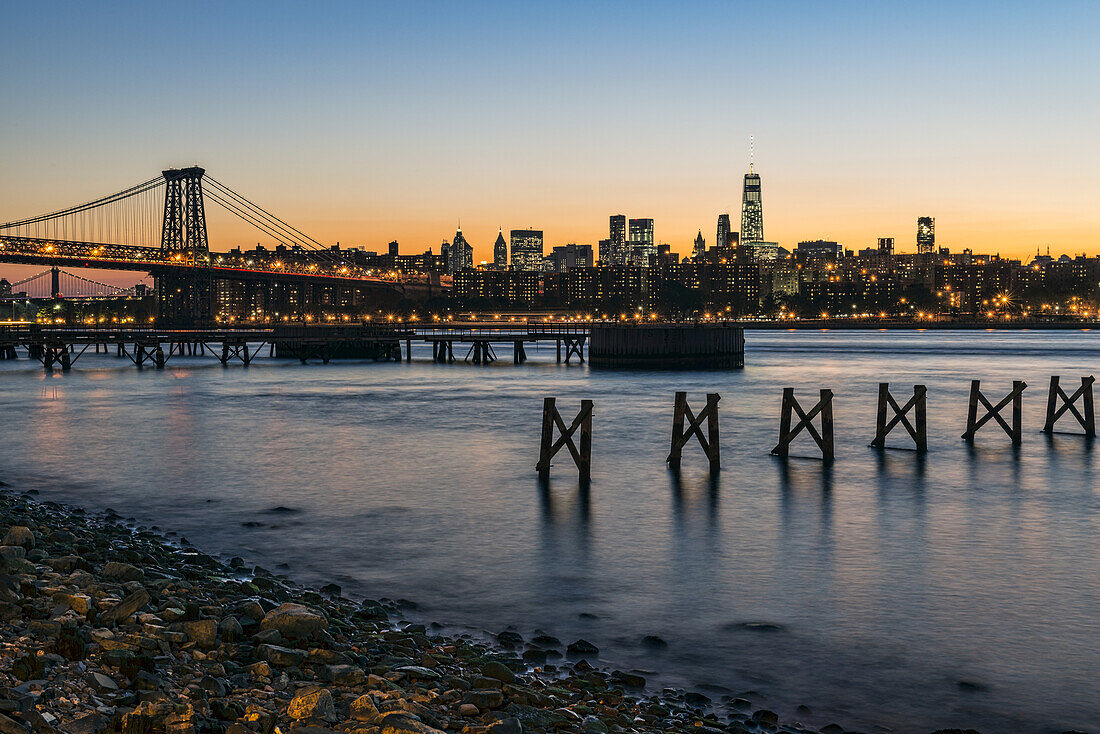 Sunset Over Lower Manhattan Near World Trade Center And Williamsberg Bridge; Brooklyn, New York, United States Of America