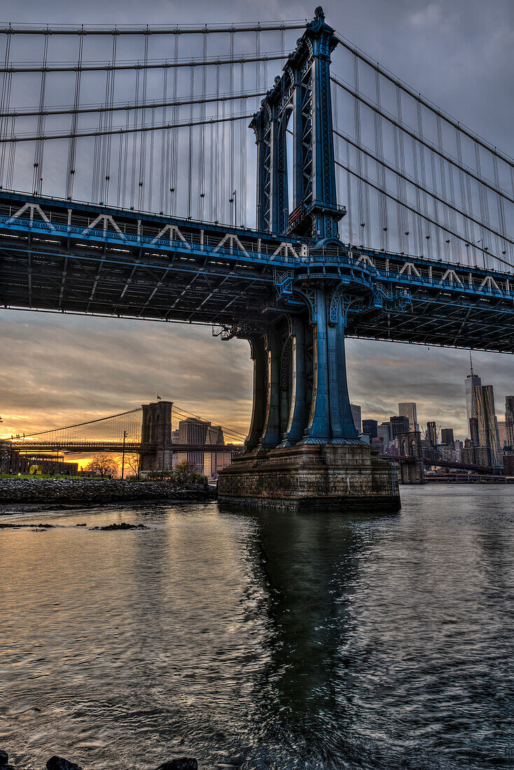 Manhattan And Brooklyn Bridges At Sunset,  Brooklyn Bridge Park; Brooklyn, New York, United States Of America