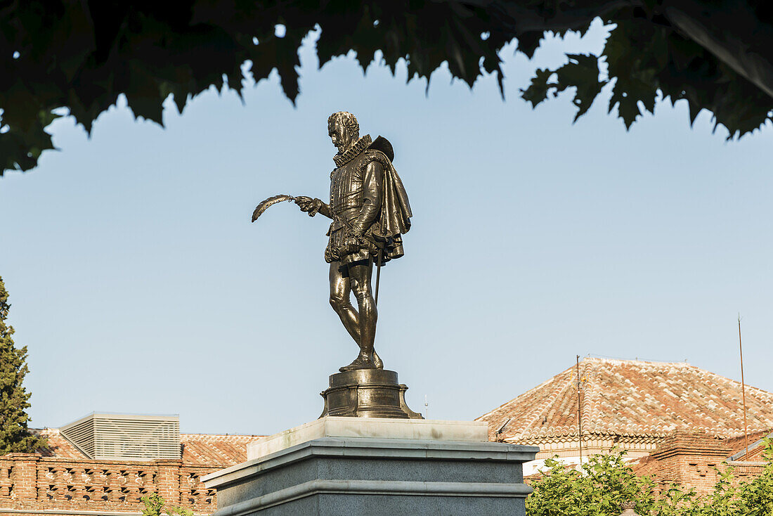 Statue And Buildings In Downtown Alcala De Henares, Cervantes Square, A Historical And Charming City Near To Madrid; Alcala De Henares, Spain