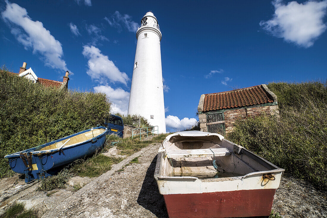 Rowboats On The Shore At The Base Of St. Mary's Lighthouse On St. Mary's Island; Whitley Bay, Tyne And Wear, England