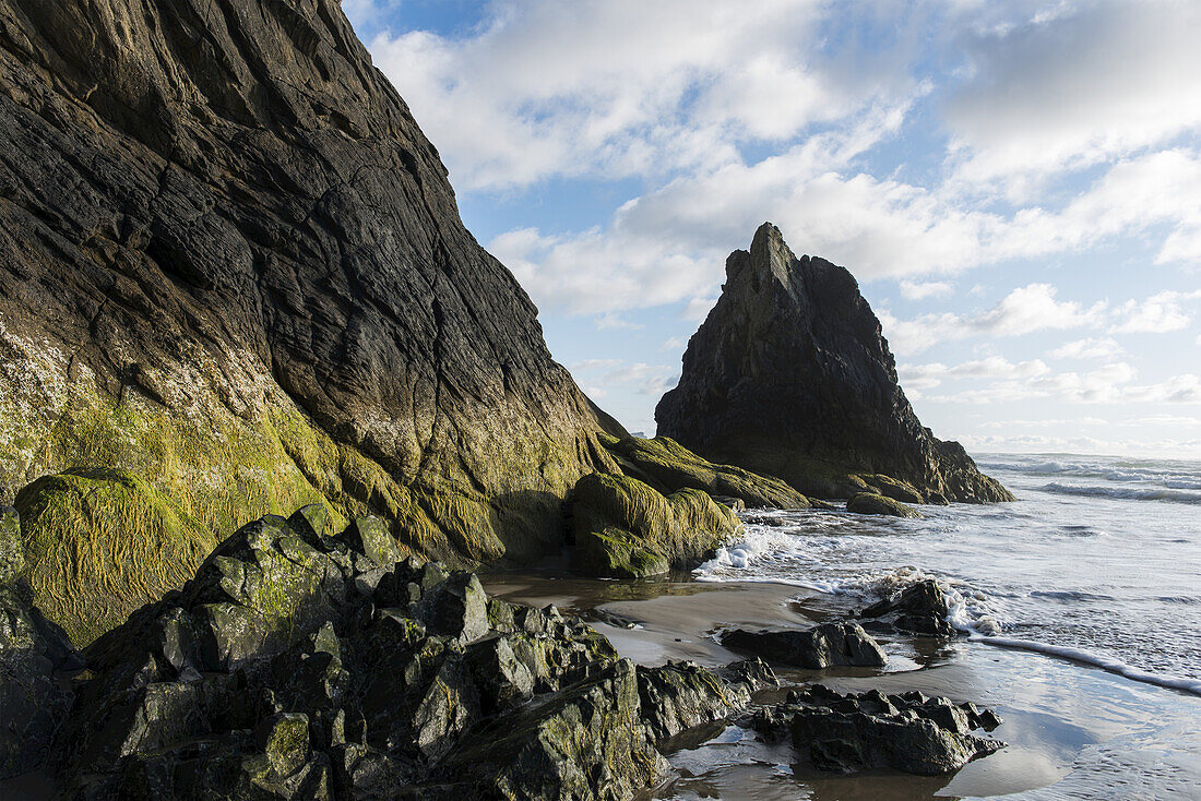 Rock Extends Into The Surf On The Oregon Coast; Oregon, United States Of America
