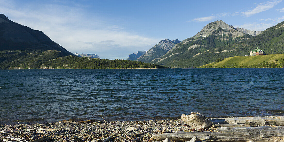 Upper Waterton Lake And Mountains With Prince Of Wales Hotel, Waterton Lakes National Park; Alberta, Canada