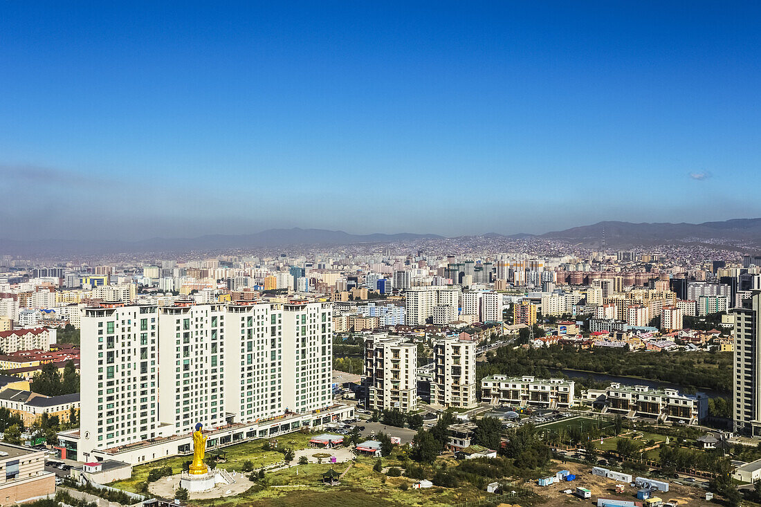 View Of Ub City, Mongolia, From Zaisan Hill, With Colourful High-Rise Apartments In The Centre Surrounded By The Single-Family Dwellings Of The Ger District On The Hills In The Background.  The Golden Buddha Statue Can Also Be Seen; Ulaanbaatar, Mongolia