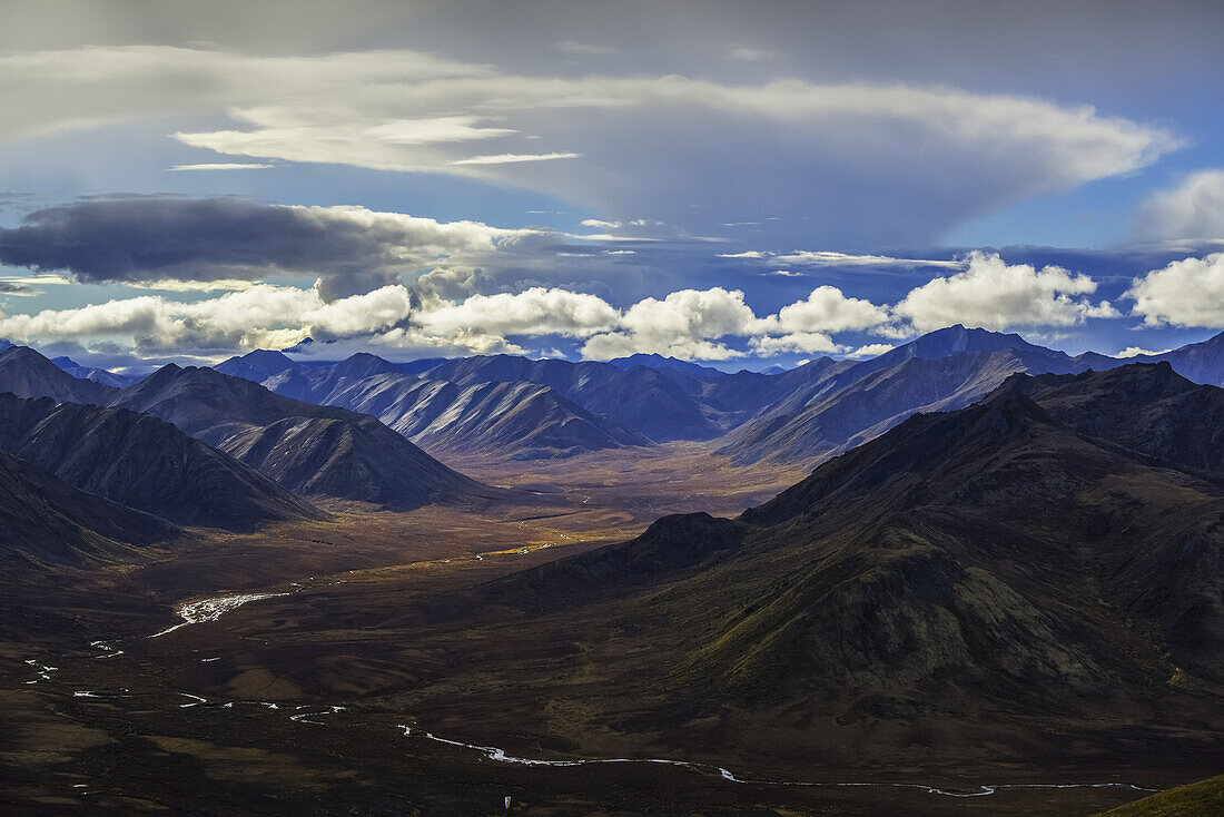 The Blackstone Valley With The West Blackstone River Flowing Out Of It During Autumn Along The Dempster Highway; Yukon, Canada
