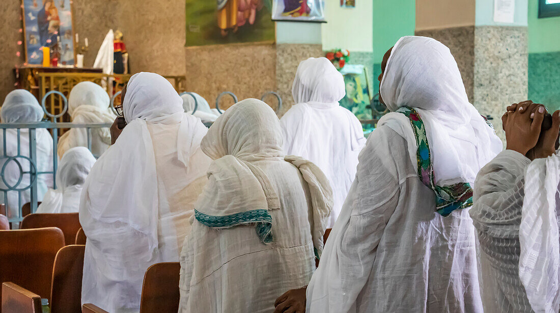 Eritrean women in white hijabs at the Enda Mariam Cathedral; Asmara, Central Region, Eritrea