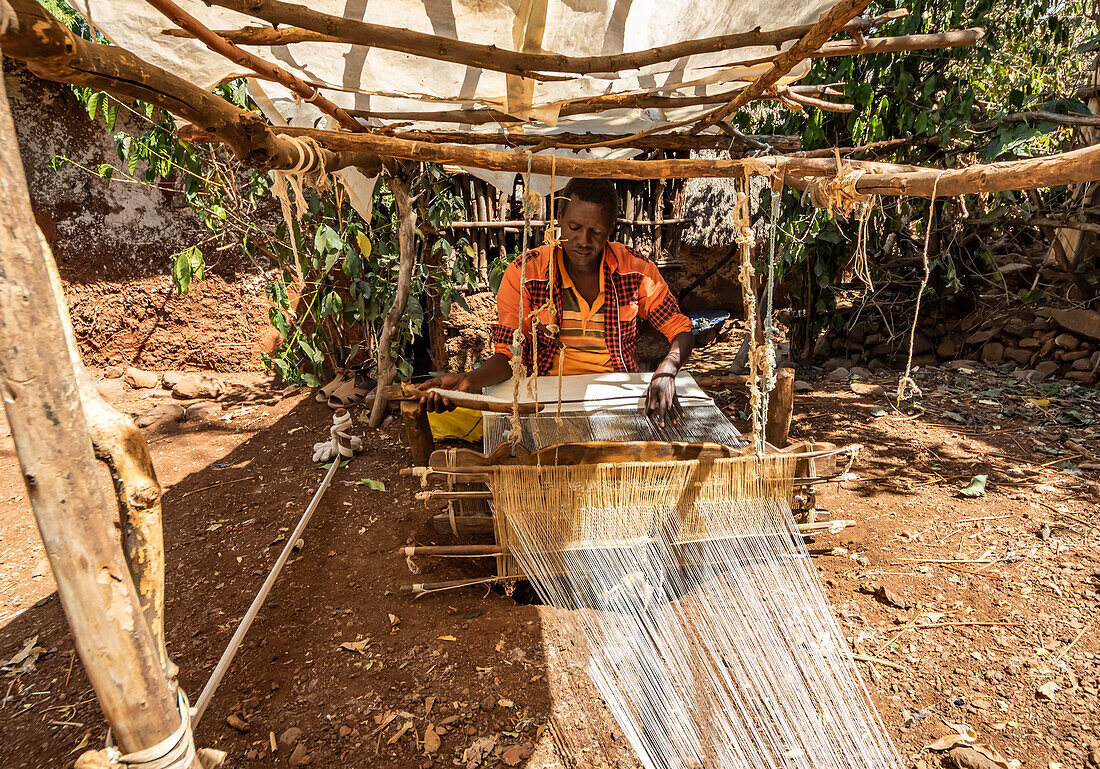 Konso man weaving cloth on his loom; Karat-Konso, Southern Nations Nationalities and Peoples' Region, Ethiopia