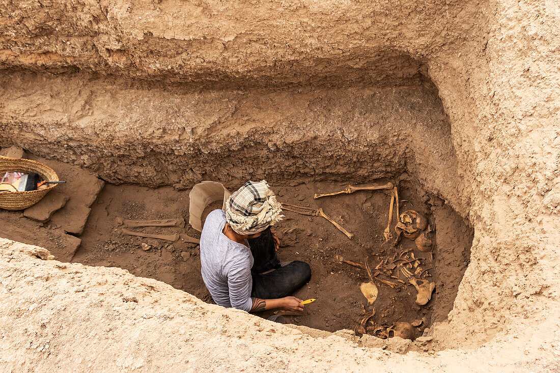 Archaeologist working on a skeleton found in an excavation of a tomb in the Napatan-Meroitic Necropolis of Sedeinga: Sector II (7th century BCE - 3rd century CE); Sedeinga, Northern State, Sudan